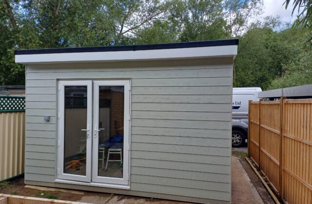 Completed insulated garden room in Sawston clad in low-maintenance hardie board with a flat EPDM roof