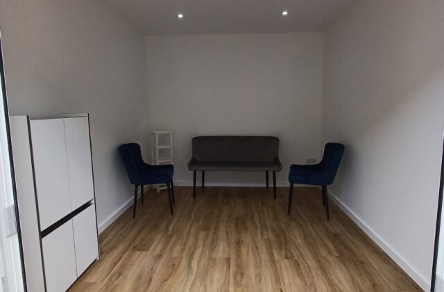Interior of the Sawston garden room with oak-effect LVT flooring and recessed LED downlights